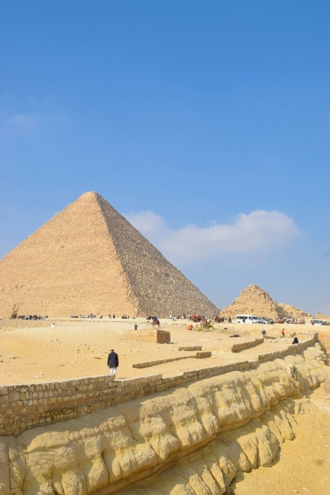 a group of people standing in front of a pyramid