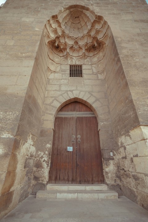 a very tall building with a big wooden door