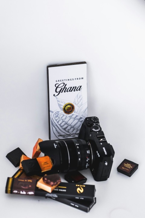 black dslr camera near chocolate packets