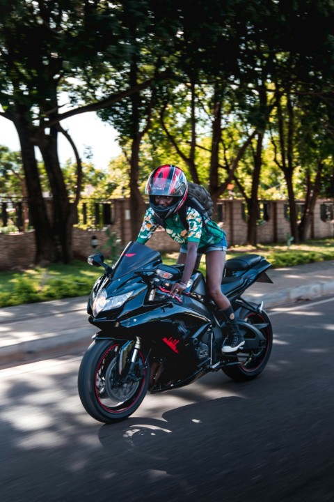 woman on black sport motorcycle in street