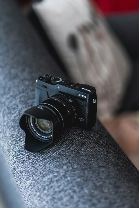 black camera on gray cushion