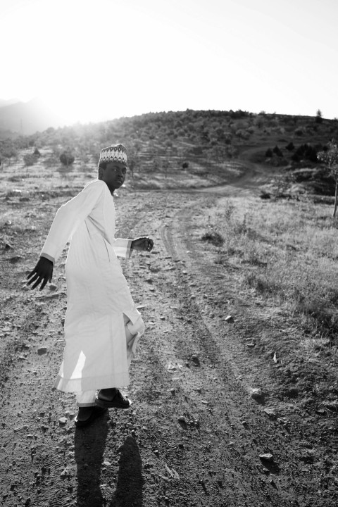 a man walking on a dirt road