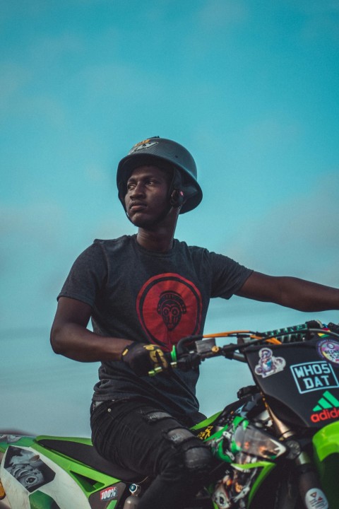 man in black crew neck t shirt and black helmet riding orange and black bicycle