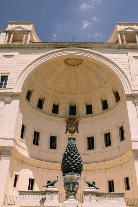 a large white building with a clock on the front of it