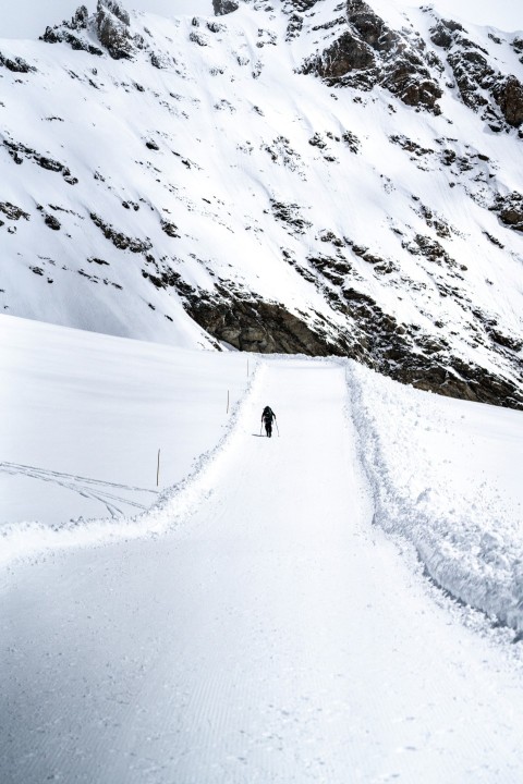 a person walking up a snow covered hill