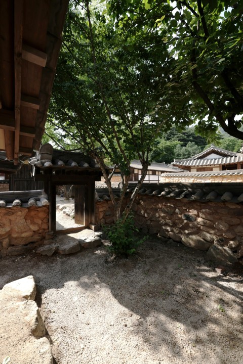 a stone building with a tree in front of it