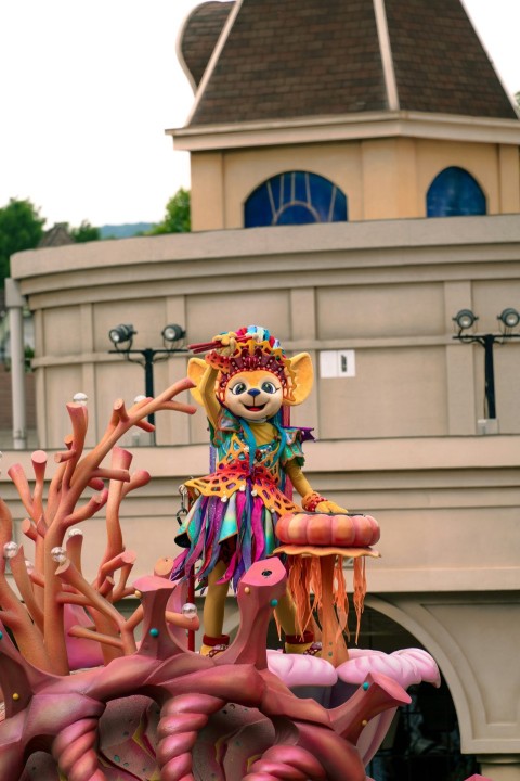 a statue of a clown on top of a building