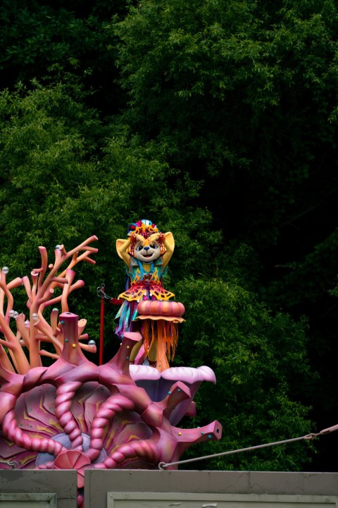 a carnival float with a clown on top of it