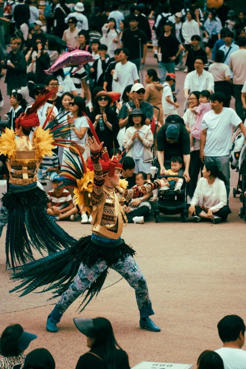 a group of people standing around a crowd of people