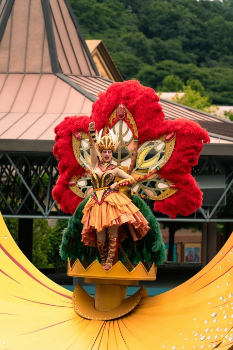 a woman is dressed in a costume and holding a fan