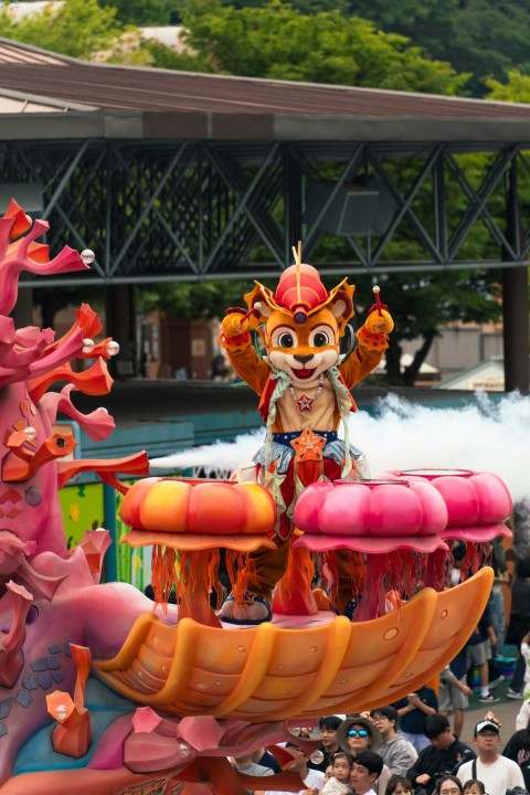 a parade float with a dragon on top of it vkVs