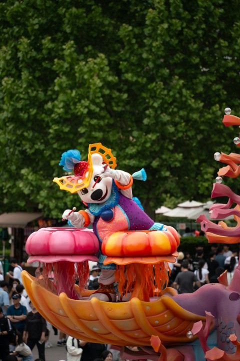 a parade float in the middle of a crowd of people