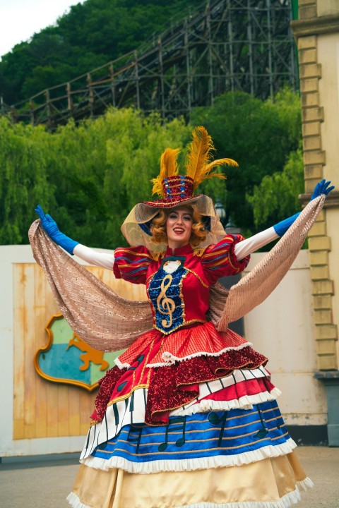 a woman dressed in a colorful dress and hat