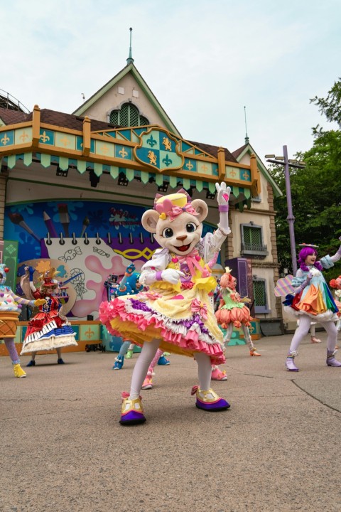 a group of people in costume dancing in front of a building