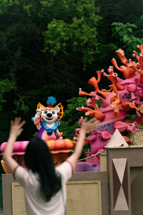 a woman standing in front of a carnival float