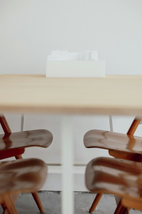 a table with two chairs and a white box on top of it wNCEKSro0