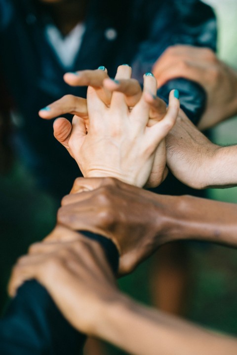 persons hand on top of mans hand