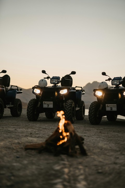 silhouette of people riding atv during sunset