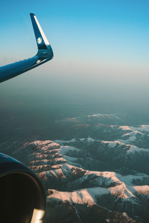 a view of the mountains from an airplane window RT8n4C8