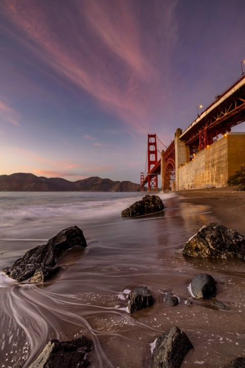 a view of the golden gate bridge from the beach