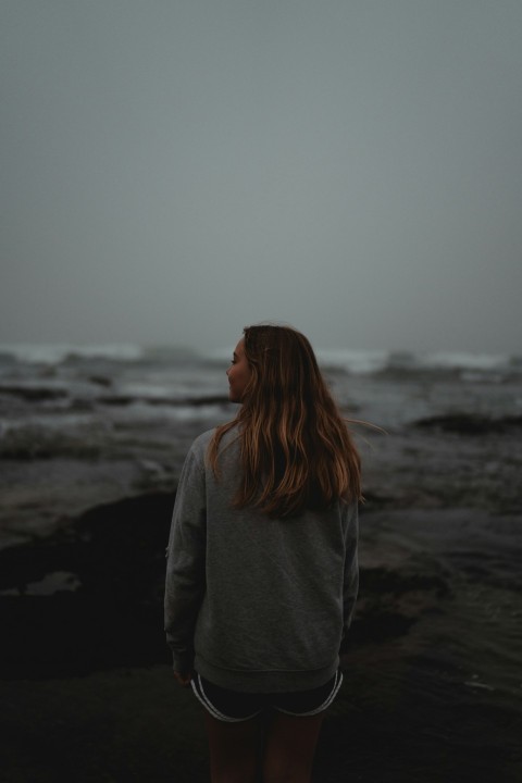 a woman standing on a beach