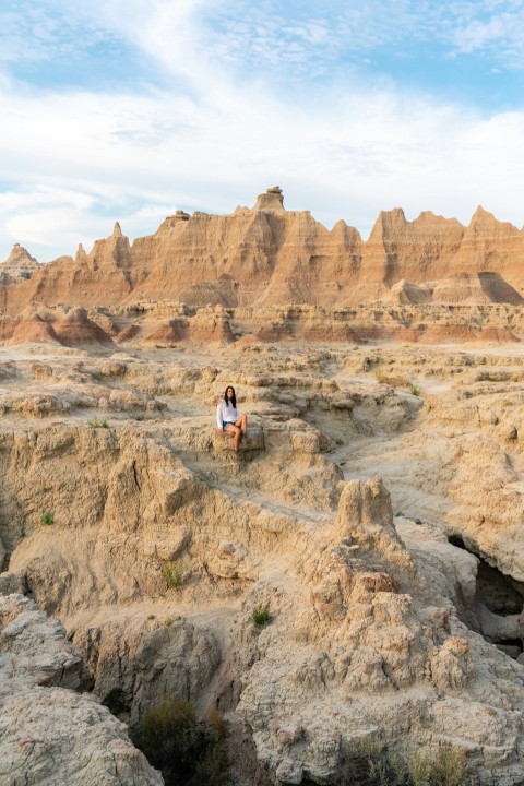 2 person standing on brown rock formation during daytime