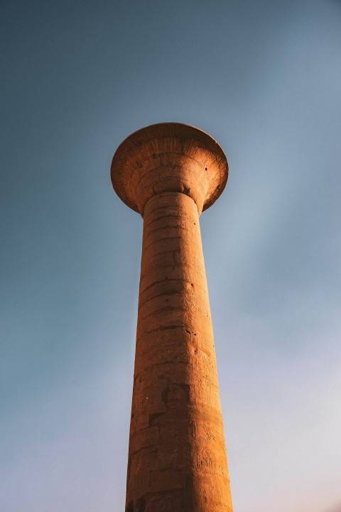 a tall brick tower with a sky background lrPUHAF