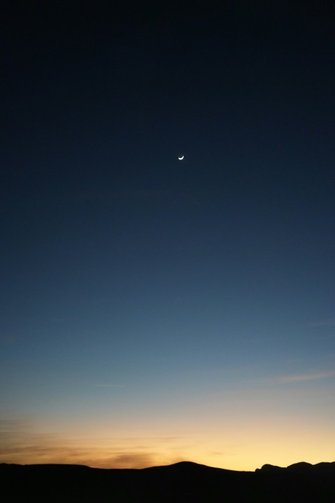 a view of the moon and a distant object in the sky