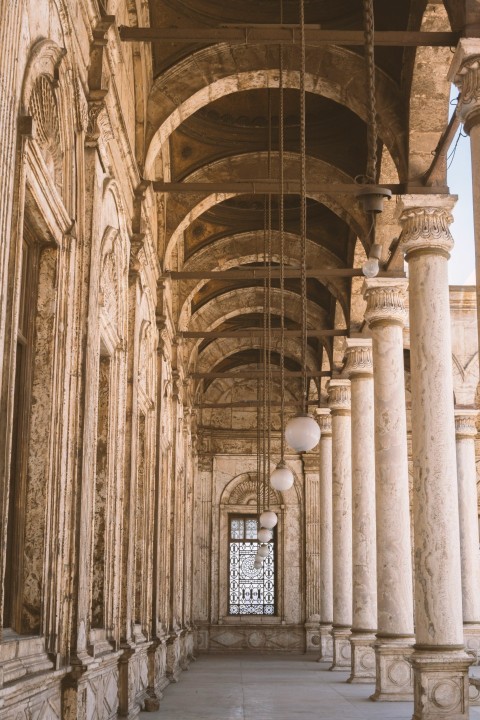 a building with columns and a clock on the wall