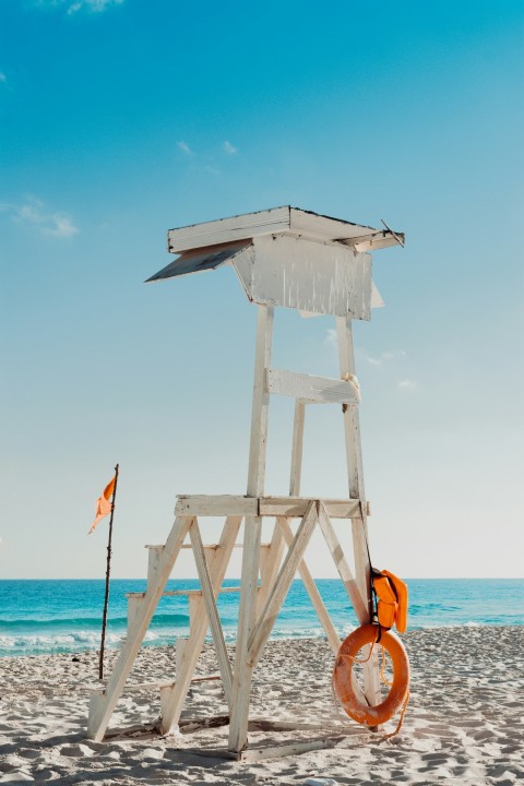 a life preserver on a beach with a life preserver