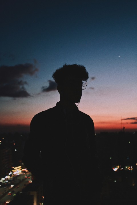 silhouette of man standing during sunset