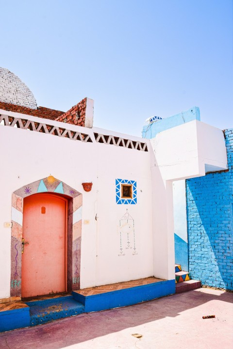 a white building with a red door