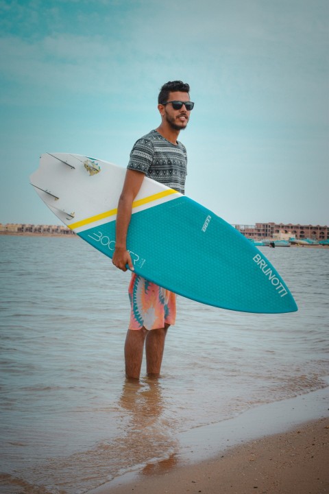 a man holding a surfboard 0JlU8