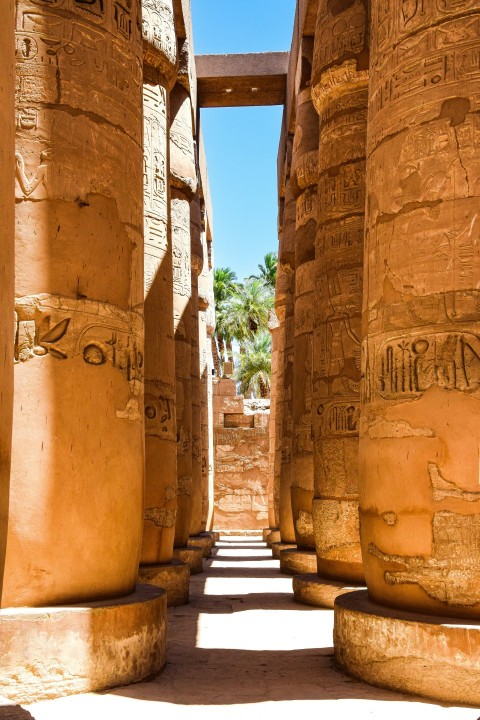 a narrow walkway between two large stone pillars