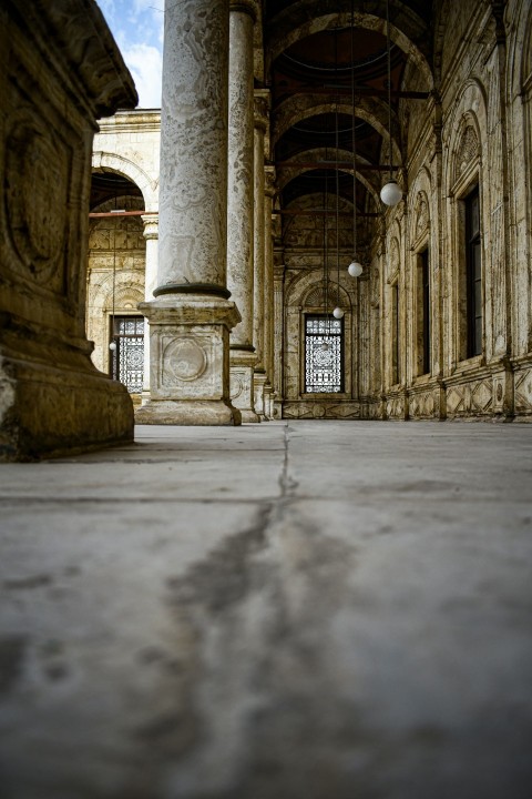 a stone building with columns and a sky background