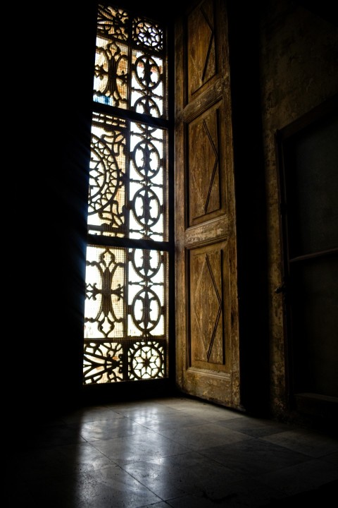 a window with a wooden frame in a dark room MrV