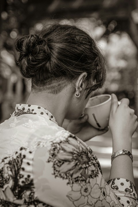 a person drinking from a cup