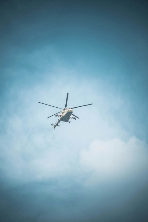 a helicopter flying through a blue cloudy sky Mt4