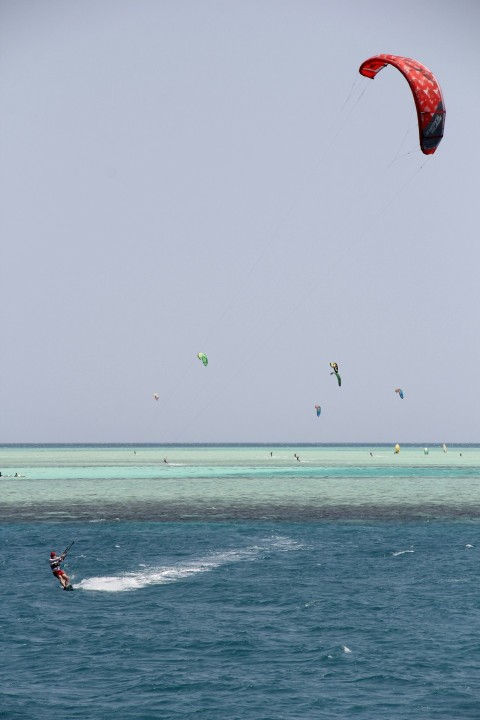 a person parasailing in the ocean on a clear day