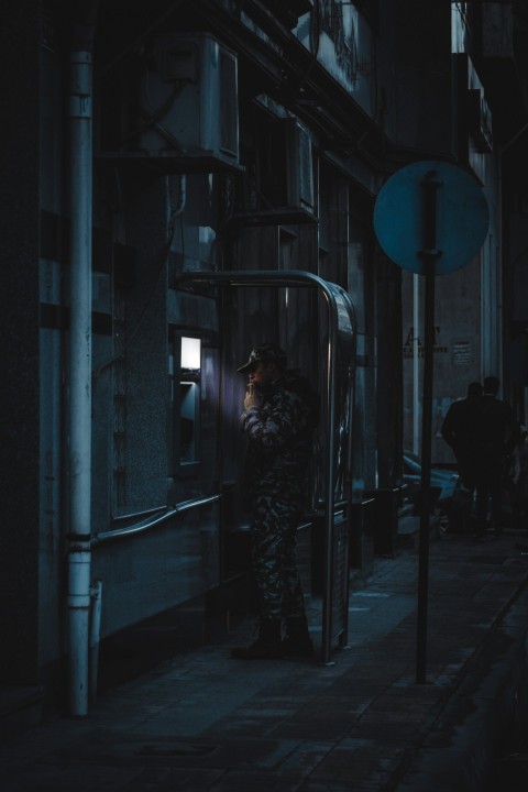 a man standing in a doorway of a building at night