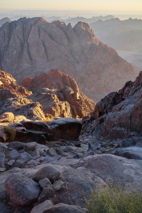 a rocky mountain with a valley below