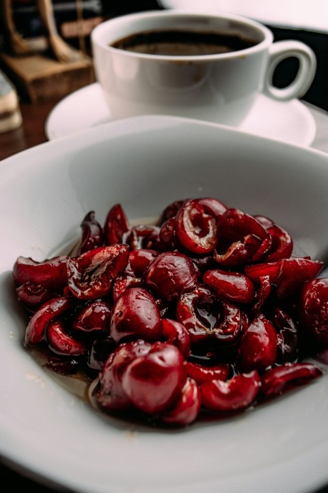 red fruits on white ceramic bowl