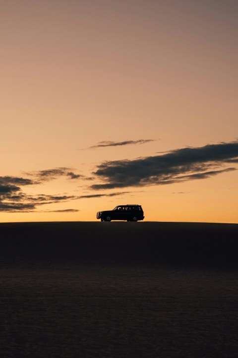 silhouette of van on seashore during sunset CfrXi