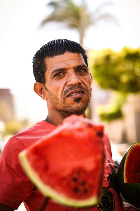 a man holding a red and white object KZkZ1Ua