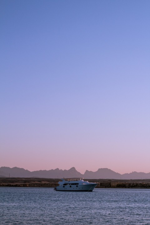 white and blue boat on sea during daytime