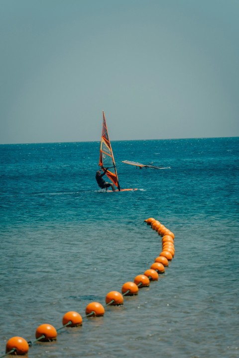 a person on a sailboat in the water