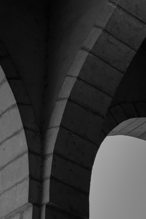 grayscale photo of concrete bridge