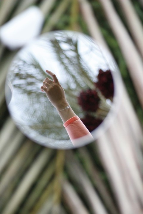 a reflection of a persons hand in a mirror