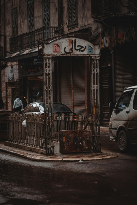 a car parked in front of a building on a rainy day