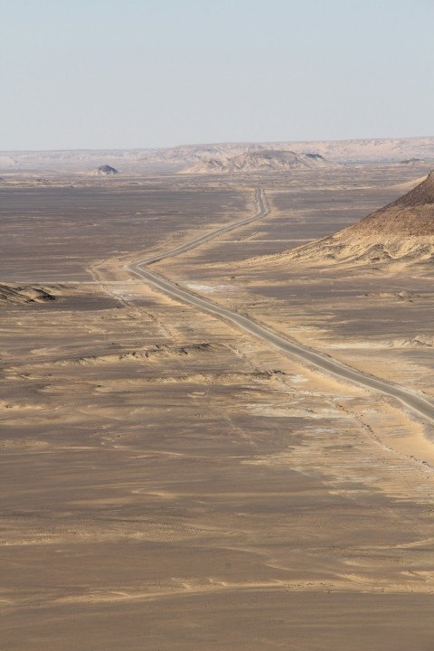 a dirt road in the middle of a desert